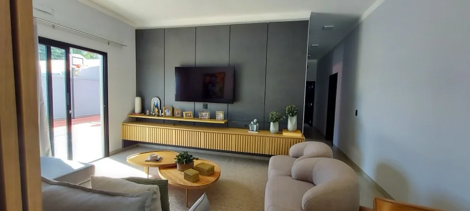 Home theater planejado em MDF grafite com estantes espelhadas e ripado de madeira em ambiente amplo